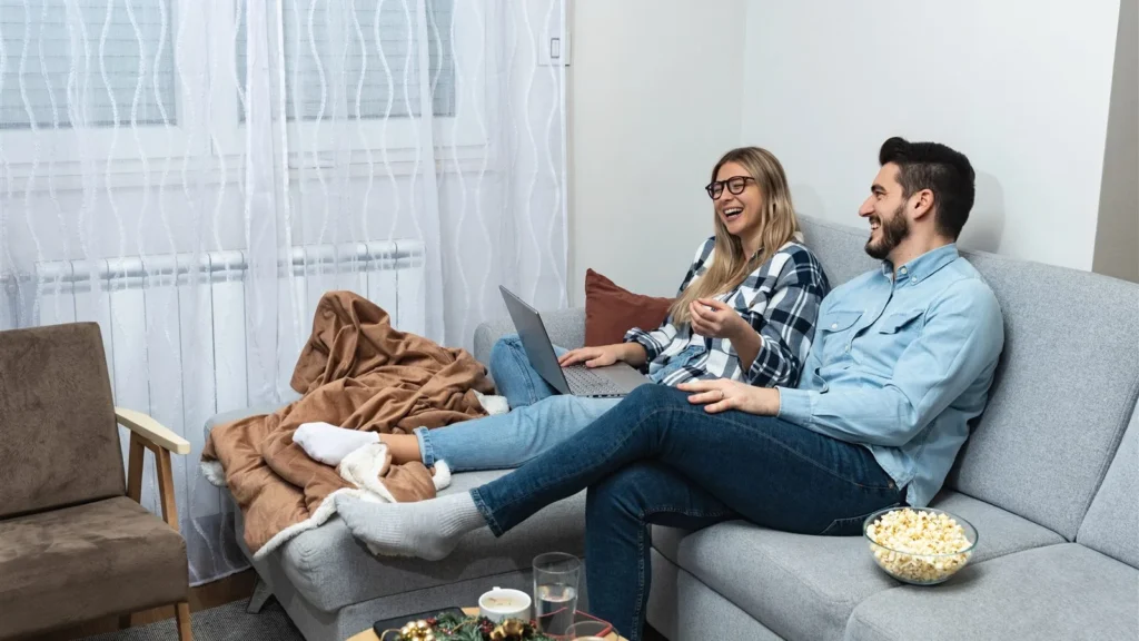 Couple reviewing wedding planning notes at home