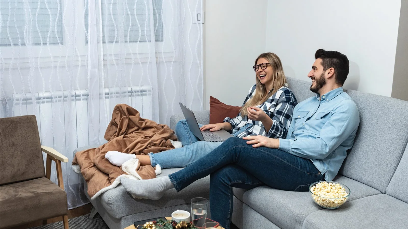 Couple reviewing wedding planning notes at home