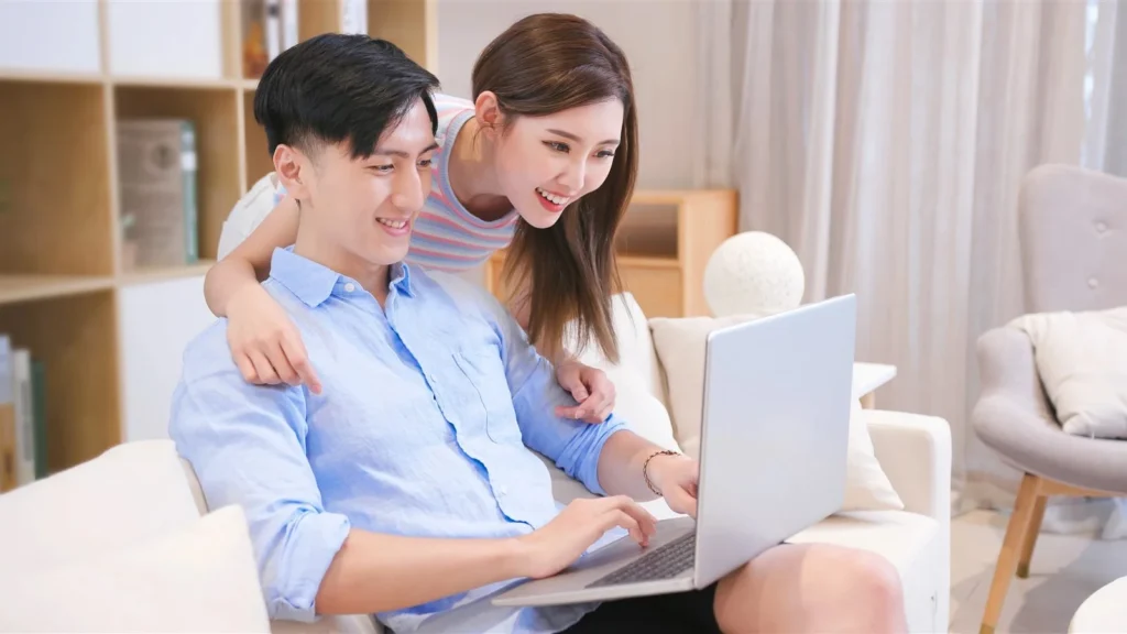 Couple researching wedding choices together on a laptop